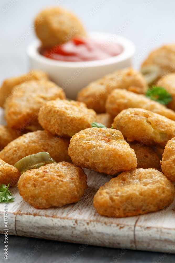 Crispy Jalapeno Popper with creamy cheese battered on white wooden board