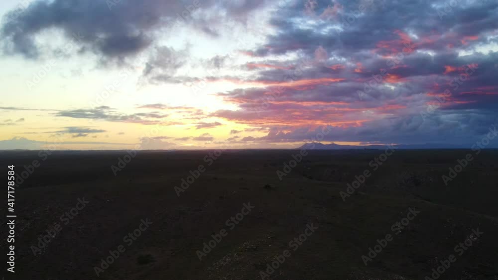 Drone flying towards hills during sunset Drone flying towards hills during sunset
