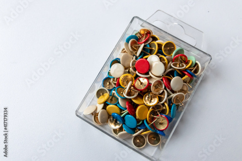 Bunch of many colorful thumbtacks as multi-color office supply metal pushpins circles in yellow, green, blue, red and white as design collection for business pins and school organization equipment