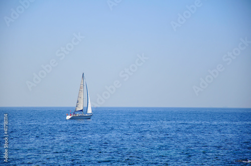 A sailing boat sailing into the sea.