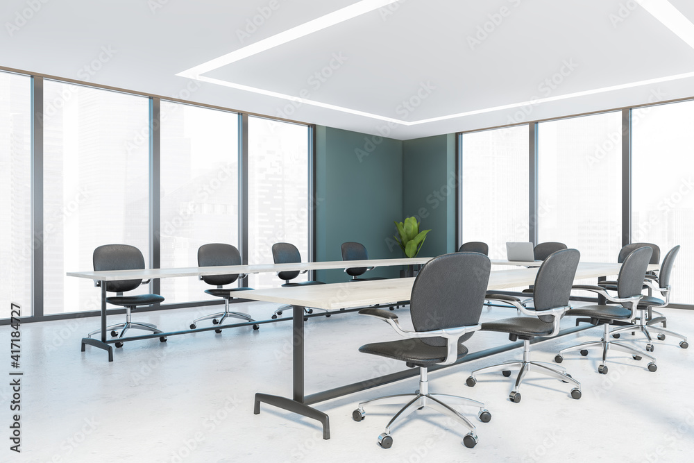 Office conference room with white wooden u-shape table and leather chairs, windows