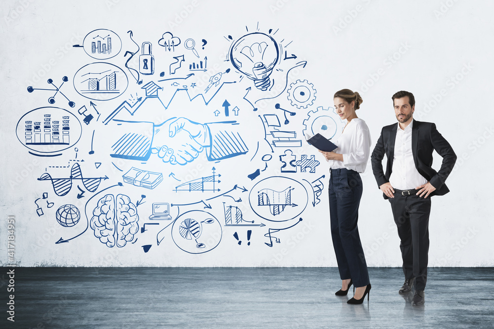 Two colleagues, man and woman standing near business strategy pl