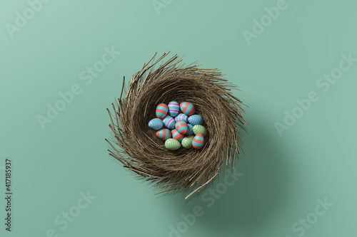 Canvas Print Colored easter eggs in a nest on a green background
