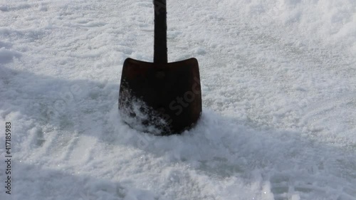 Old ice screw for winter fishing in action. Drilling hole in ice close up view
