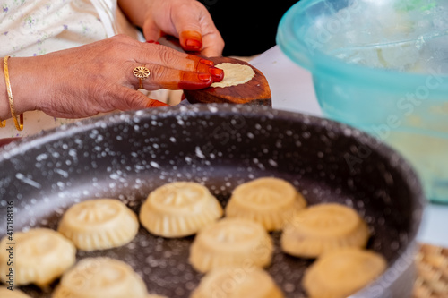 Arabic woman hands making eid sweets ,cookiesand mamoul
