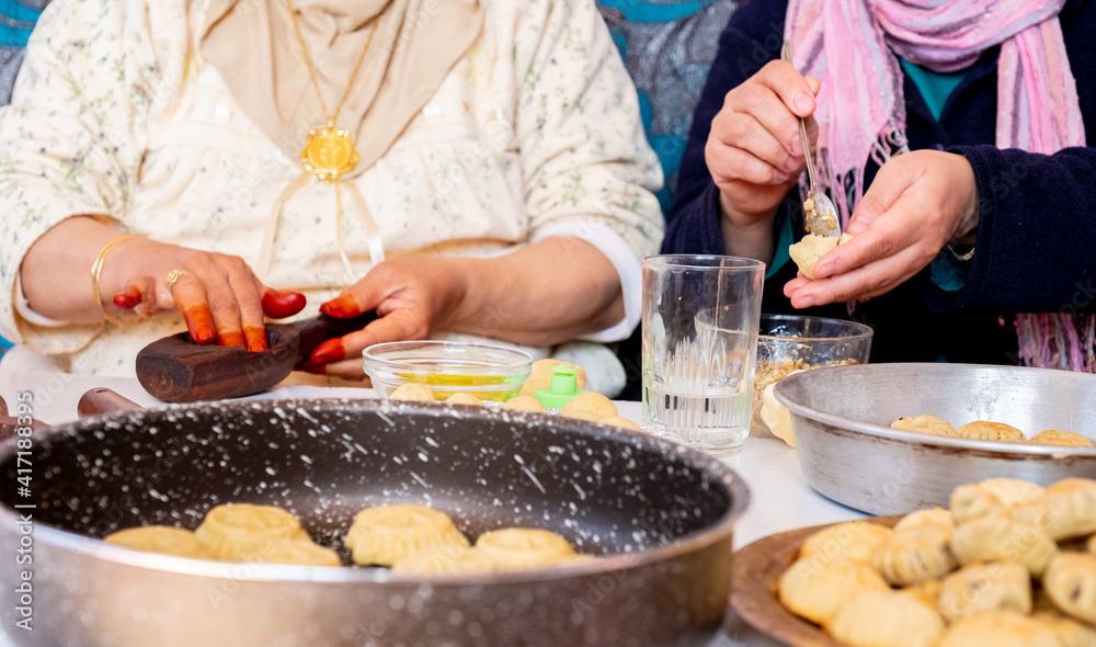 Arabic woman hands making eid sweets ,cookiesand mamoul