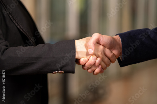 Close up hand of businessman and businesswoman shaking hand together