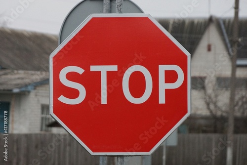 one metal road sign stop on the street on gray background