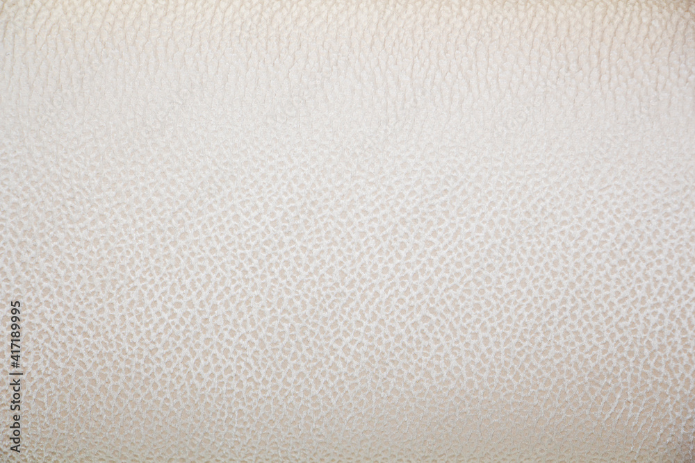 Piece of silver, beige faux leather texture close-up