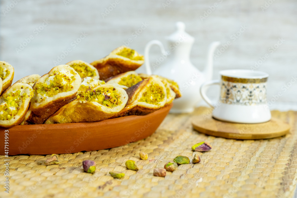 Ramadan sweets qatayef with white background and arabian coffee cups