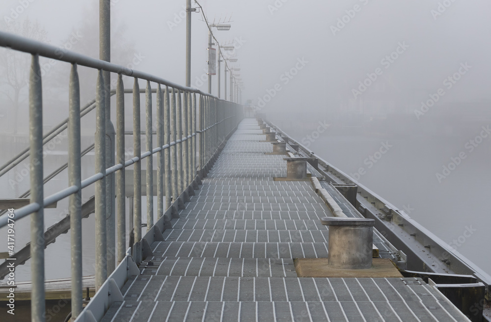 Empty pier on misty morning by a river. Shot in Sweden, Scandinavia