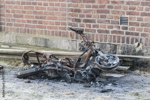 Burnt and abandoned moped on the ground. Shot in Sweden, Scandinavia photo