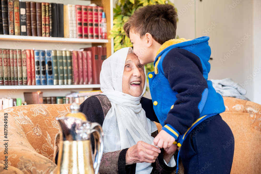 Arabic family enjoy eid celebration with grandmother while laugh Arabic family enjoy eid celebration with grandmother while laugh