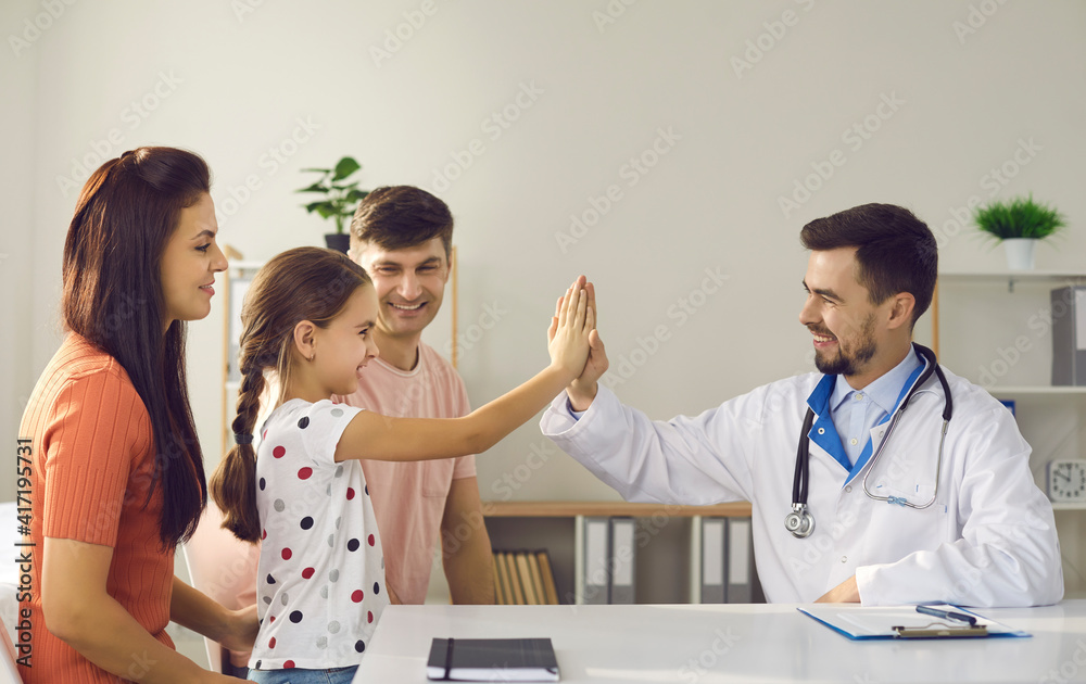 Fototapeta premium Mom, dad and child seeing family doctor at his office. Happy girl high-fiving friendly pediatrician. Concept of healthcare for children, trust, little patients' positive attitude to visiting hospital