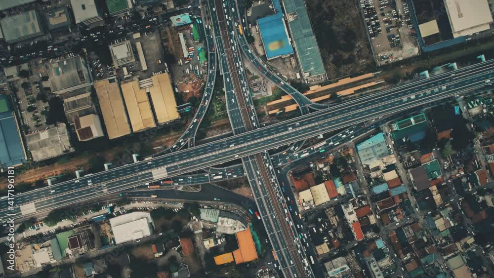 Top down of bridge crossroad with cars, trucks aerial. Cityscape transportation. Downtown streets with buildings. Urban transport at traffic highway. Cinematic drone shot. New York city, USA, America
