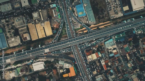 Top down of bridge crossroad with cars, trucks aerial. Cityscape transportation. Downtown streets with buildings. Urban transport at traffic highway. Cinematic drone shot. New York city, USA, America