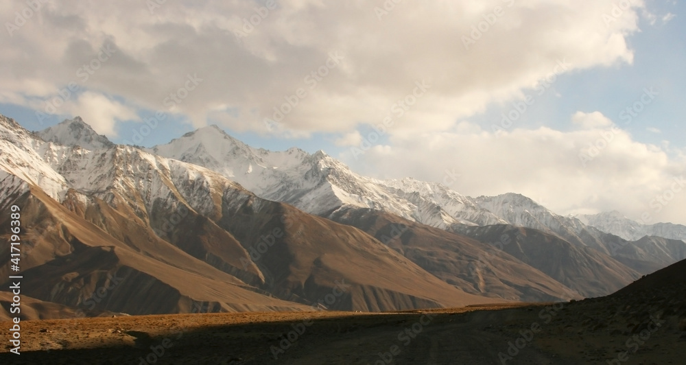 Evening view of hindukush or hindu kush mountain ridge, Tahikistan and afghanistan, view from Pamir highway or pamirskij trakt Evening view of hindukush or hindu kush mountain ridge, Tahikistan and afghanistan, view from Pamir highway or pamirskij trakt