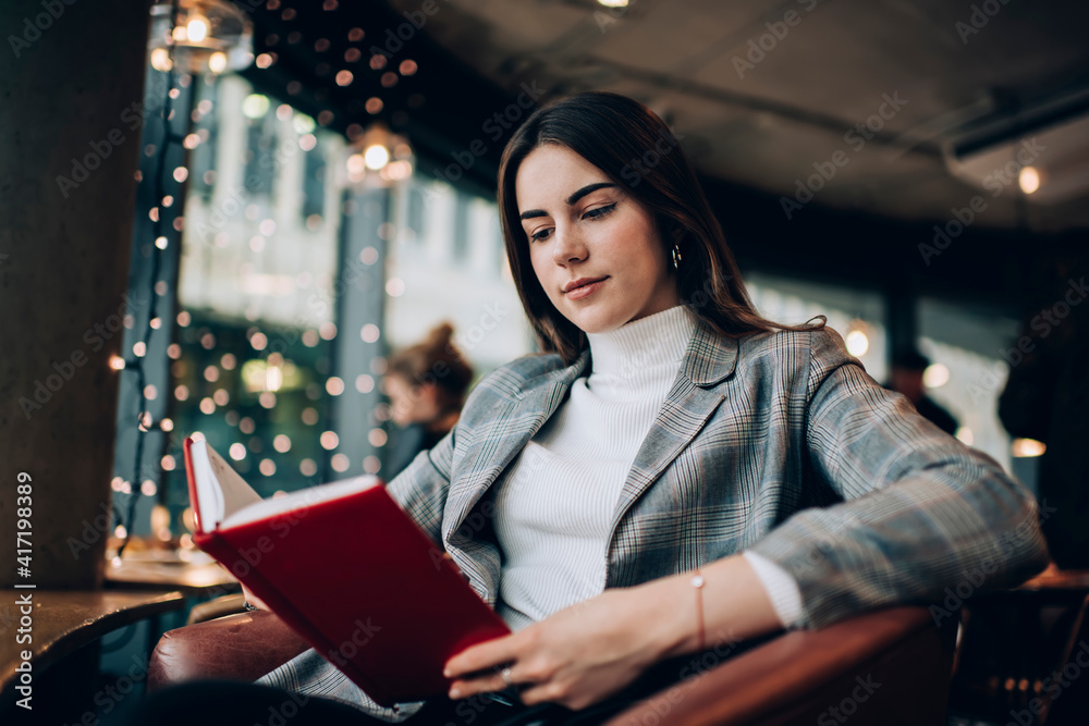 Calm woman reading book in cafe Calm woman reading book in cafe
