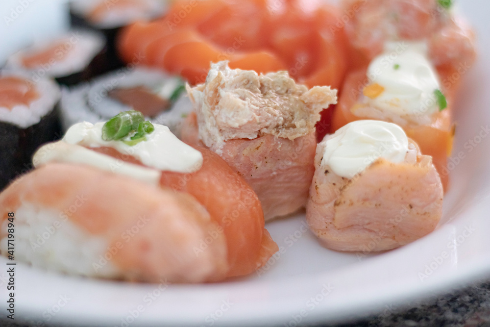 Close-up of defocus sushi and sashimi variety with ginger on a plate Close-up of defocus sushi and sashimi variety with ginger on a plate
