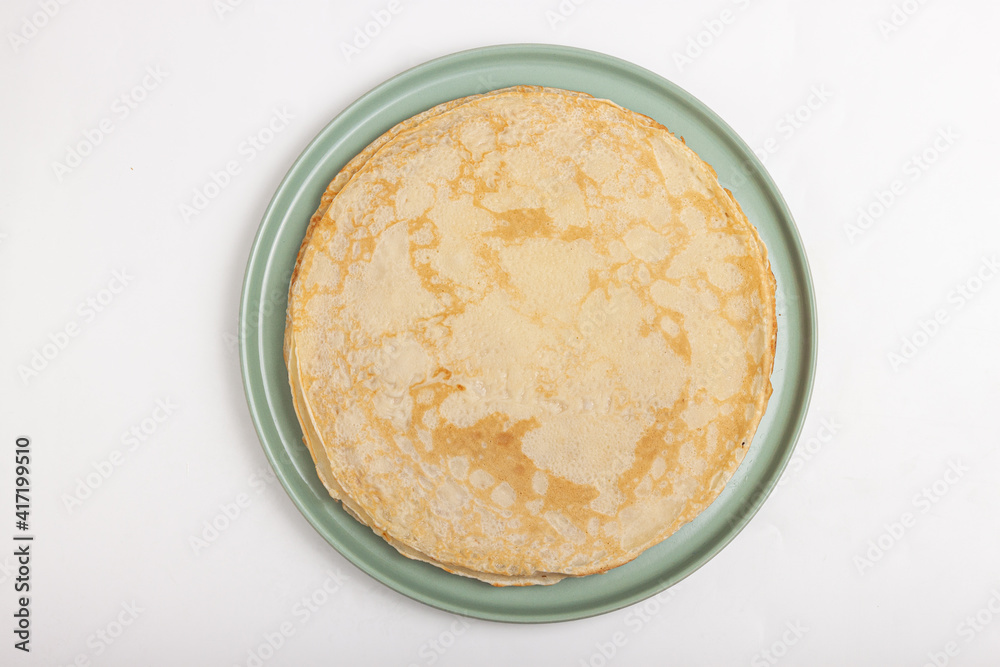 Pancake on the green plate. Many pancakes are stacked Pancake on the green plate. Many pancakes are stacked