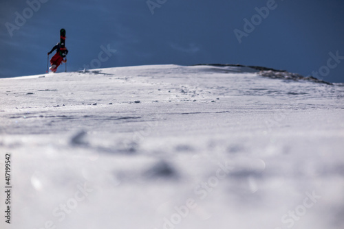 Inverno appenino bolognese, passeggiata con ciaspole snowborder che sale photo