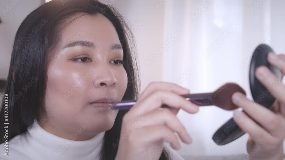 Asian woman blogger is recording a video on social media teaching teenagers about makeup. Slow motion Asian woman blogger is recording a video on social media teaching teenagers about makeup. Slow motion