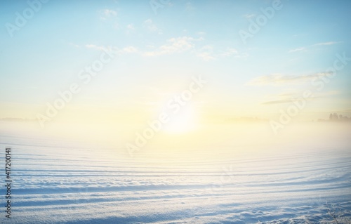 Print op canvas Breathtaking view of snow-covered field after a blizzard at sunset