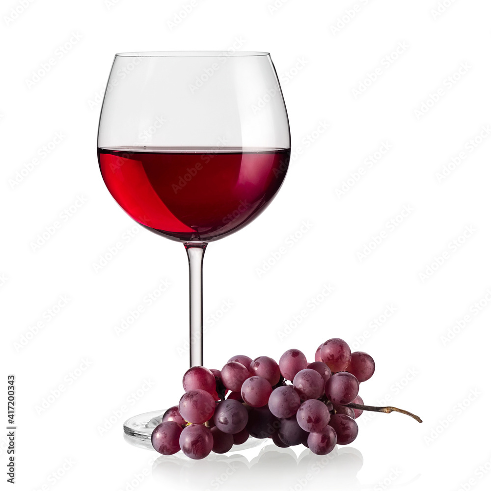 Red wine glass with red grapes, close up Red wine glass with red grapes, close up