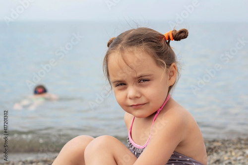 portrait of a cute little girl by the sea