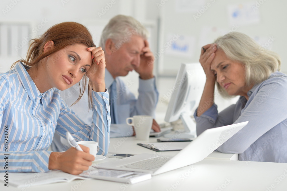 Portrait of tired businesspeople working in modern light office Portrait of tired businesspeople working in modern light office