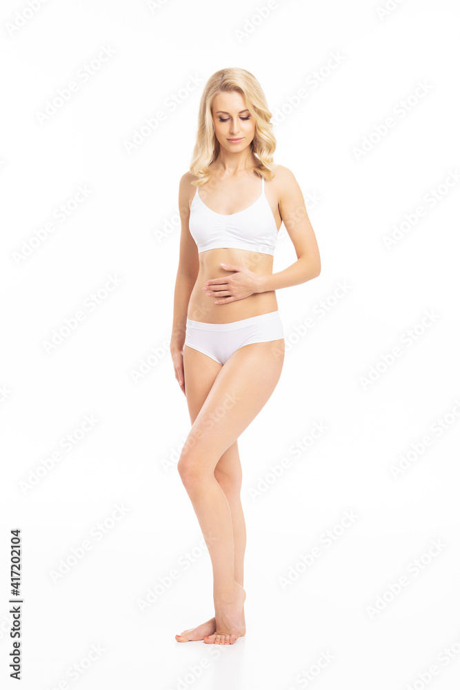 Young, fit and beautiful blond woman in white swimsuit isolated on white. Healthcare, diet, sport and fitness concept. Young, fit and beautiful blond woman in white swimsuit isolated on white. Healthcare, diet, sport and fitness concept.