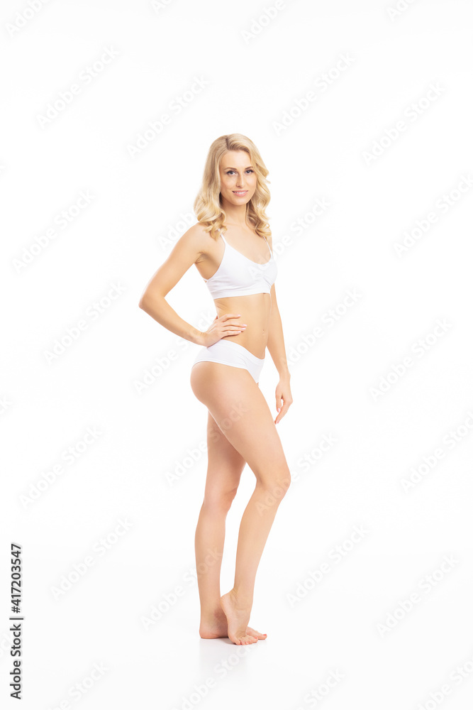 Young, fit and beautiful blond woman in white swimsuit isolated on white. Healthcare, diet, sport and fitness concept. Young, fit and beautiful blond woman in white swimsuit isolated on white. Healthcare, diet, sport and fitness concept.