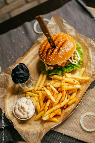 burger on a plate with french fries and sauce