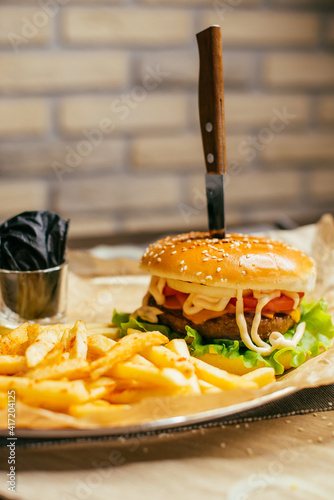 burger on a plate with french fries and sauce