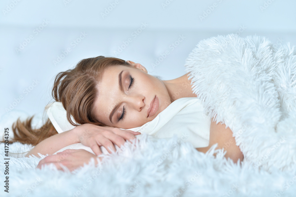 Beautiful young woman lying on soft bed Beautiful young woman lying on soft bed