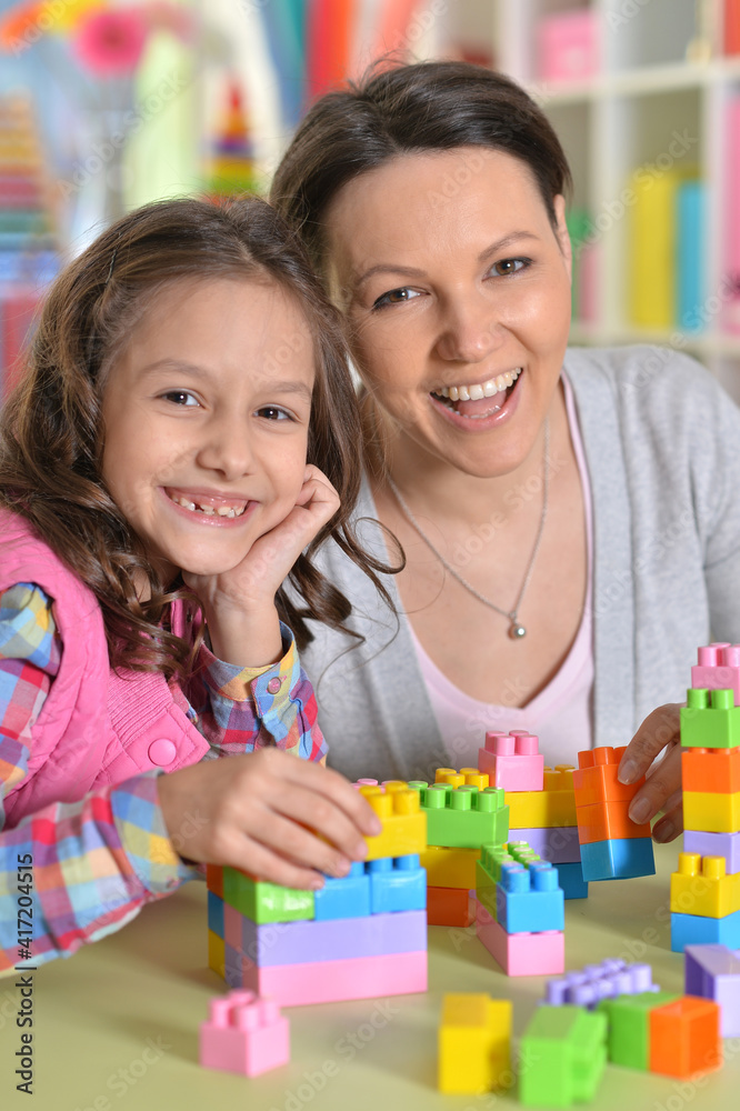 little girl and her mother playing