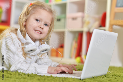 girl with headphones using laptop