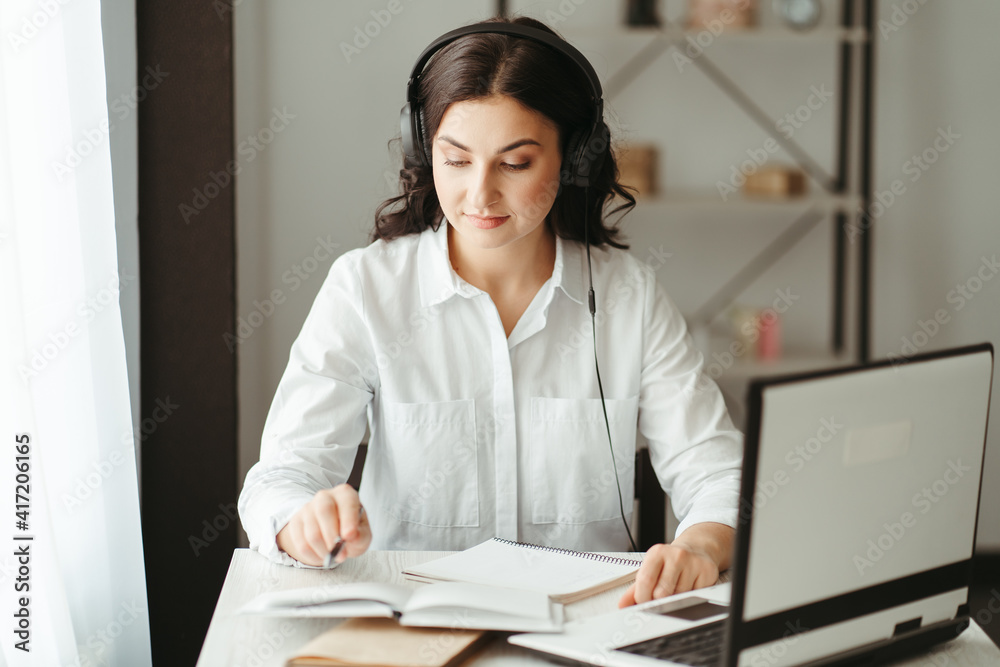 Distance education, e-learning concept. Woman using laptop computer at home, studying online. Work or study from home Distance education, e-learning concept. Woman using laptop computer at home, studying online. Work or study from home
