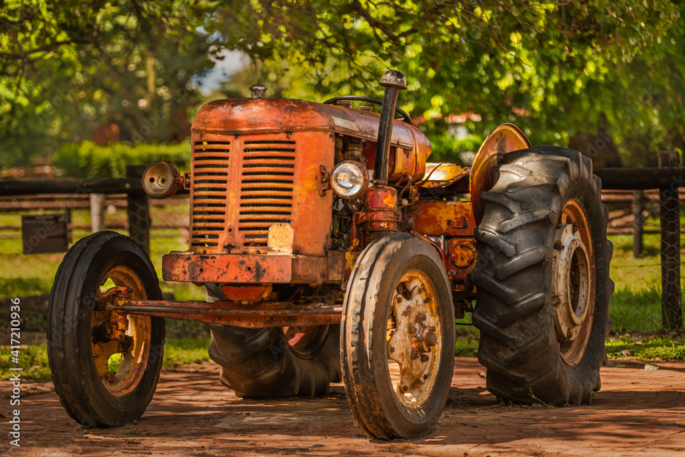 old rustic tractor in a countryside farm old rustic tractor in a countryside farm