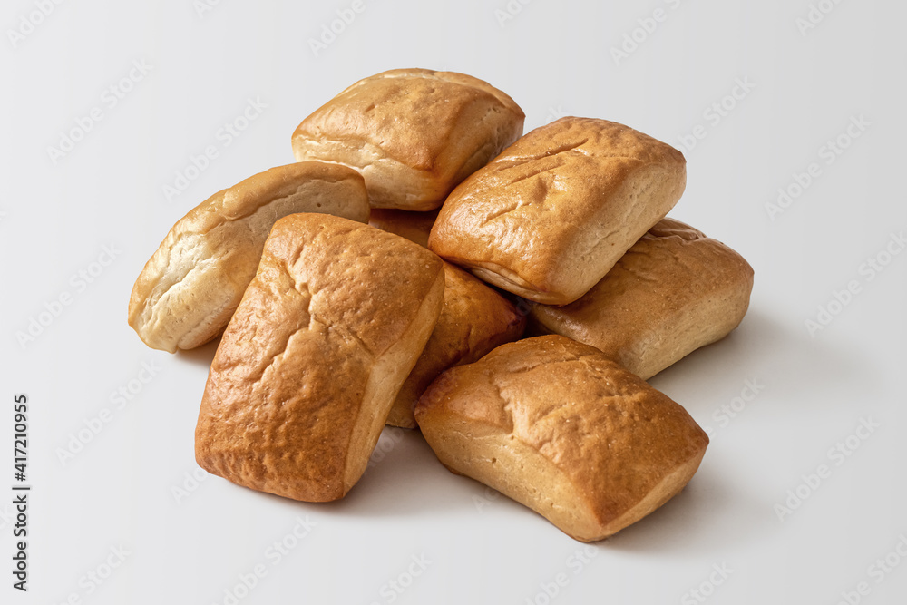 Pile of fresh buns, square-shaped on a light background