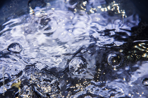 Surface of intensive boiling water with bubbles and swirls