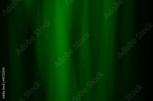 Green abstract background - lines and streaks of light. Blurred, irregular light elements on black background. Green fanciful 3d patterns.