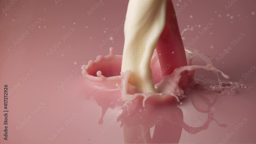 Macro shot of strawberry milkshake stream falling in slow motion
