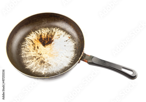 old stained aluminium pan with burnt fat and peeled off TFE non-stick coating and burnt fat isolated
