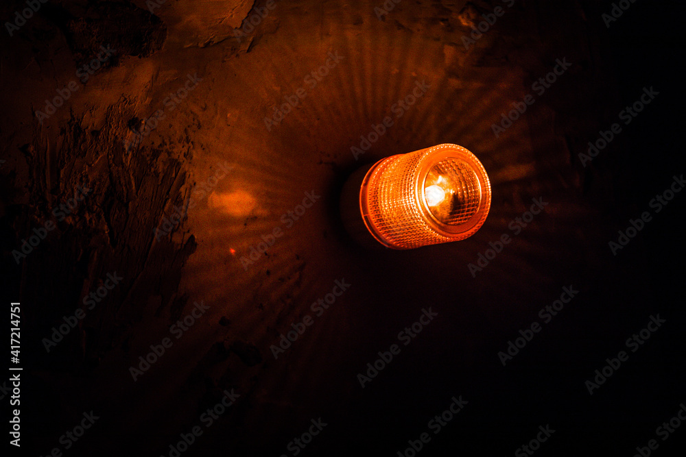 Emergency lighting in the factory, Warning light, Orange siren on concrete wall. Emergency lighting in the factory, Warning light, Orange siren on concrete wall.