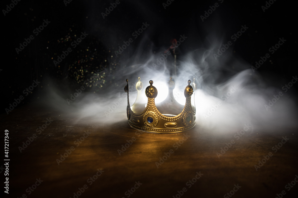 low key image of beautiful queen/king crown over wooden table. vintage ...