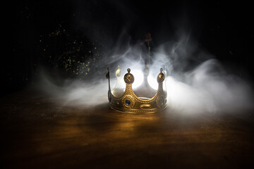 low key image of beautiful queen/king crown over wooden table. vintage filtered. fantasy medieval period
