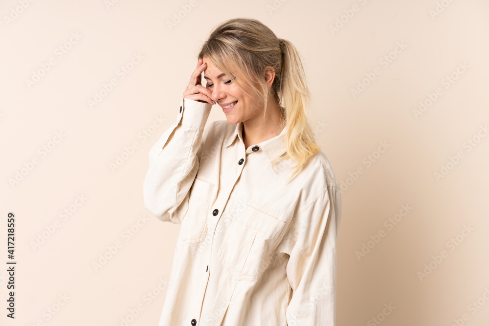 Blonde woman over isolated background laughing Blonde woman over isolated background laughing