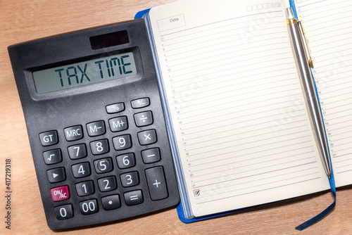 Tax Time word on calculator. Time to pay tax in year. Business and tax concept. © olmax1975