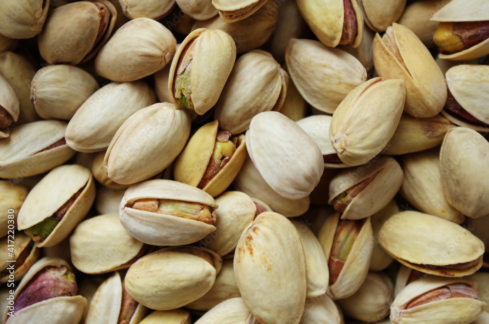 Tasty pistachios as background texture, flat lay. Pile of pistachios in the peel close up. Pistachios healthy omega-3 fatty acid. Healthy food and snacks vegan food. Tasty pistachios as background texture, flat lay. Pile of pistachios in the peel close up. Pistachios healthy omega-3 fatty acid. Healthy food and snacks vegan food.